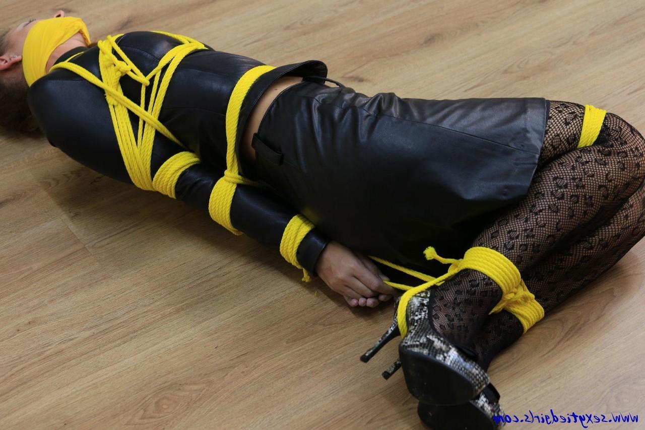 16P Caucasian girl is silenced while tied up with yellow rope in her clothing