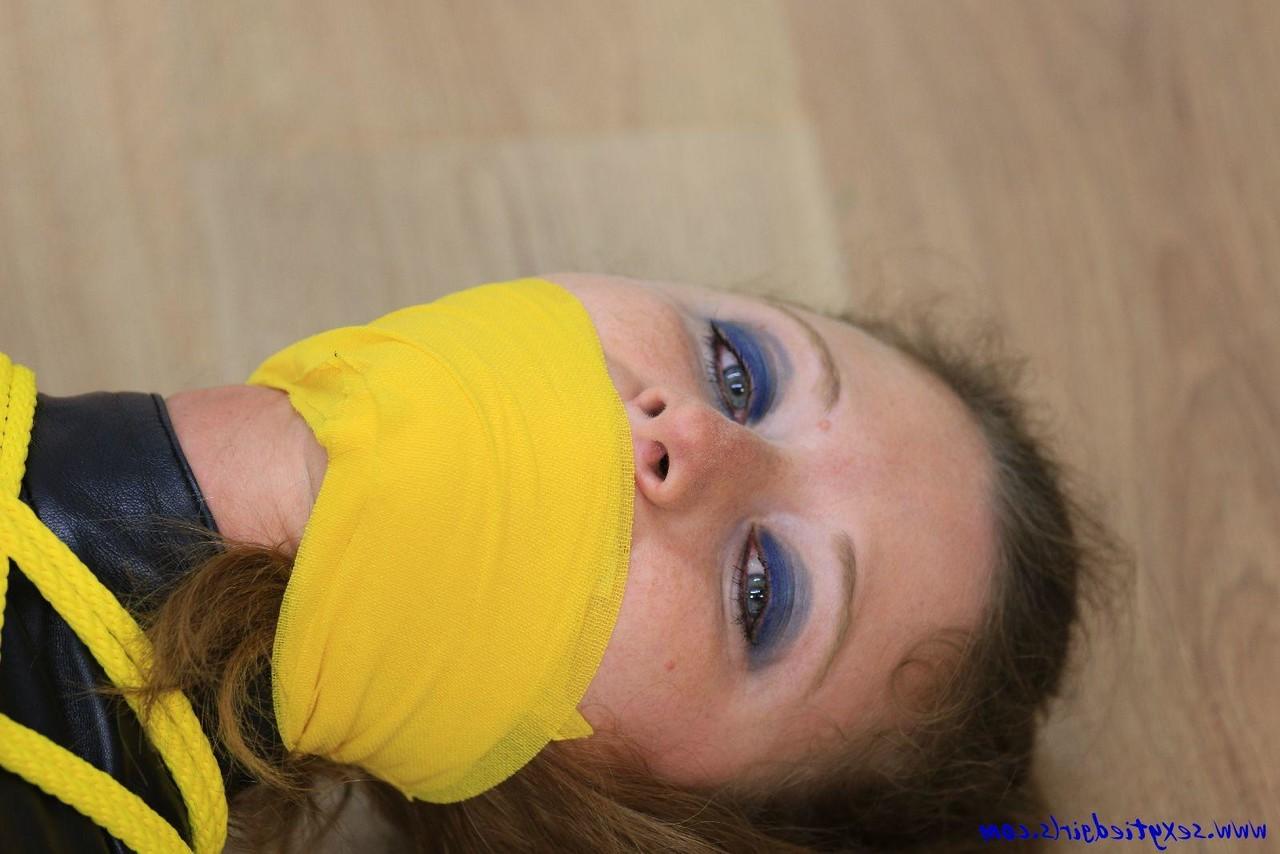 16P Caucasian girl is silenced while tied up with yellow rope in her clothing