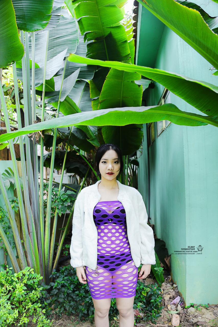 20P Brünettes asiatisches Mädchen posiert in sexy lila durchsichtigem Kleid im Freien