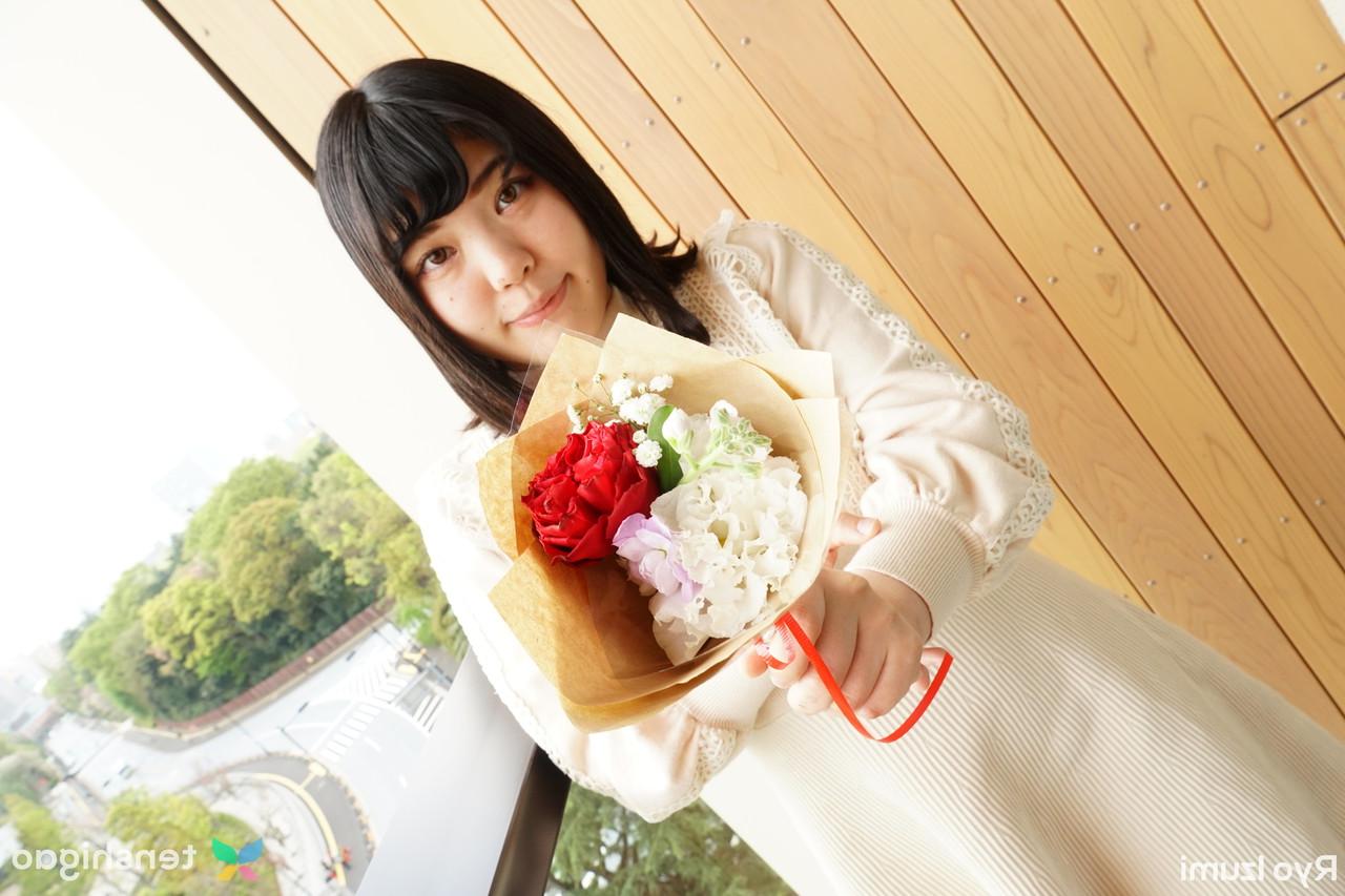 15P Das bezaubernde japanische Mädchen Ryo Izumi hält einen Blumenstrauß in der Hand, während sie nicht nackt ist