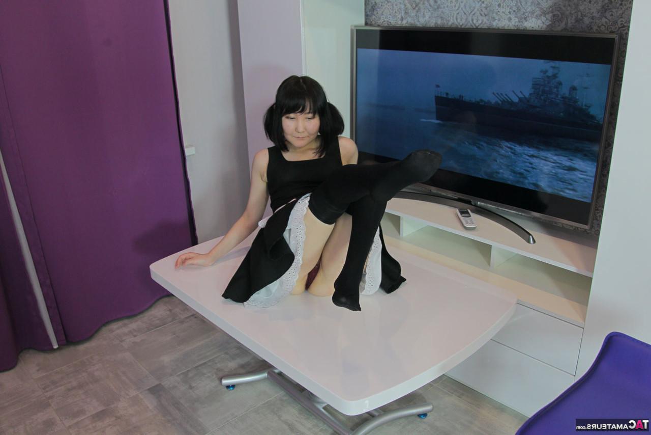 20P La chica japonesa Akuma Loli se quita los calcetines OTK negros antes de mostrar su coño