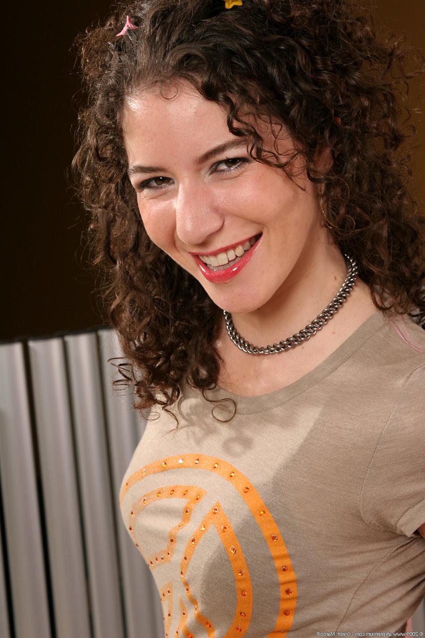 20P Curly-haired doll Sativa Verte strips off her clothes and massages her bush