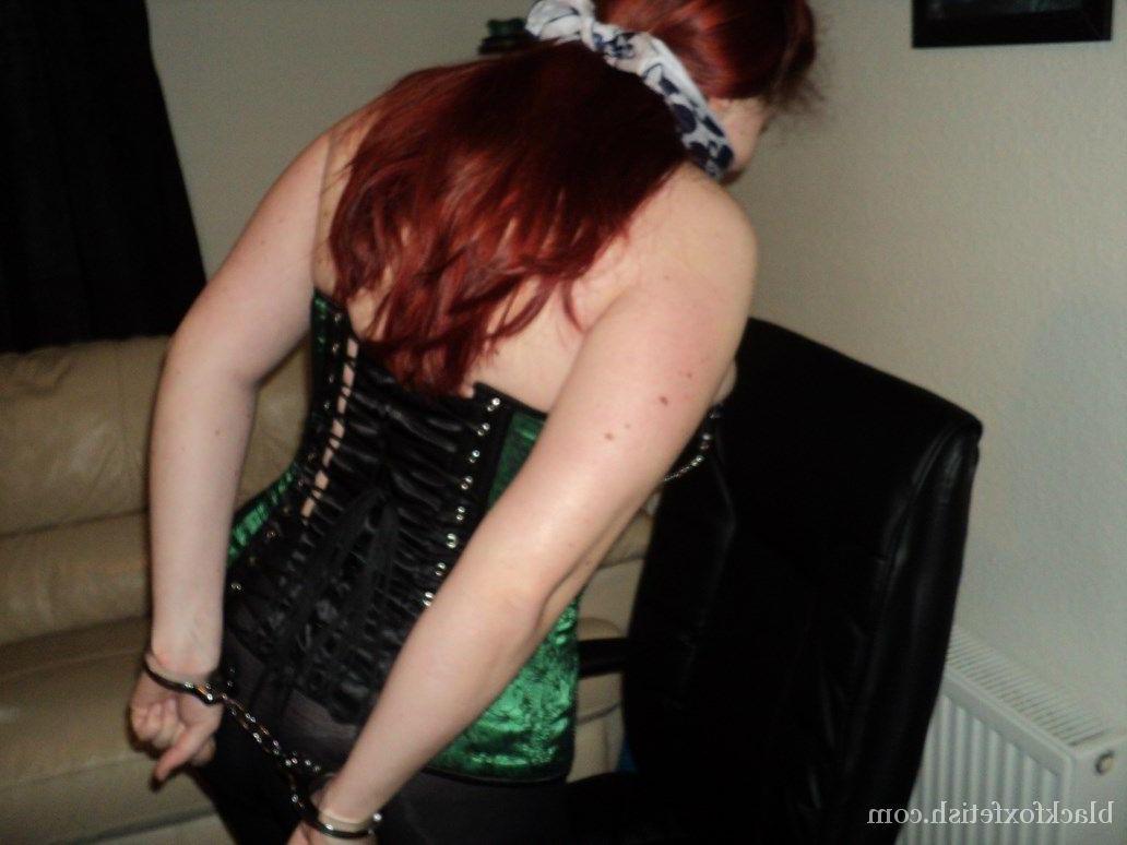16P Chubby redhead sports a cleave gag with her wrists handcuffed behind her back
