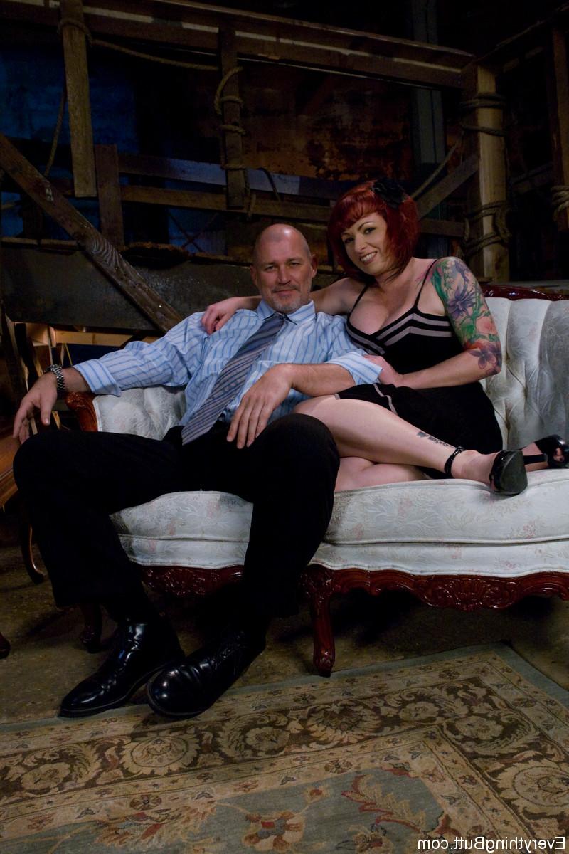 16P Tattooed redhead Kylie Ireland flashes an upskirt butt cheek on a sofa