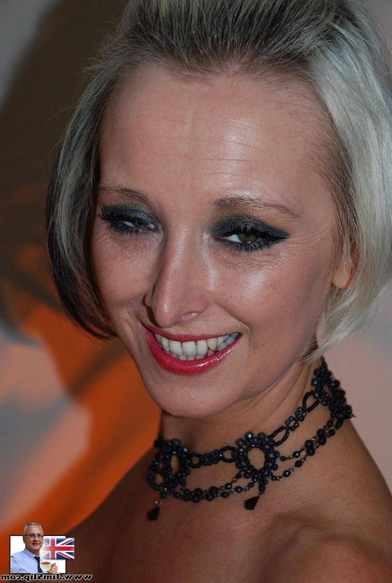 20P British model Tracy Venus in pink fishnets frees enhanced boobs for sofa fuck