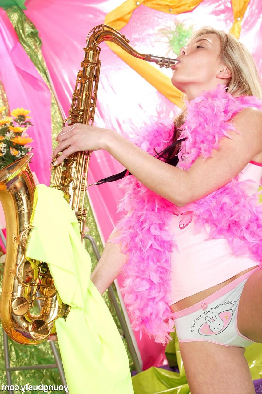 20P Blonde with a slim figure Yasmin A toys her pussy after playing her saxophone
