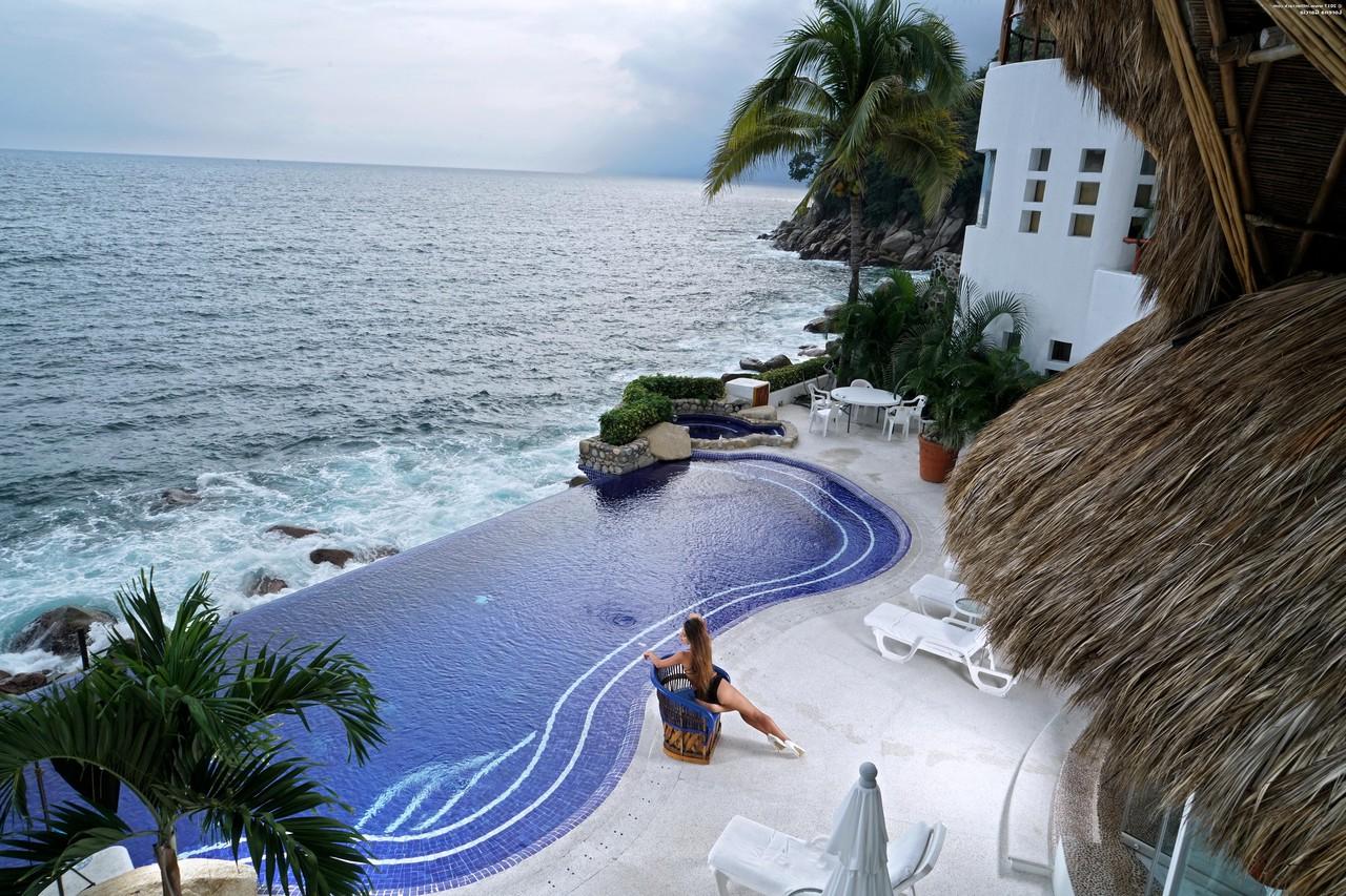20P Long haired brunette Lorena Garcia doffs her bodysuit and poses in the pool