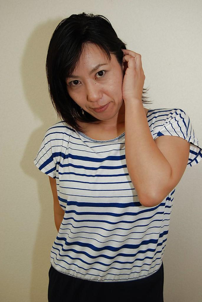 16P Astonishing Asian babe Masako undressing and showing her nipples