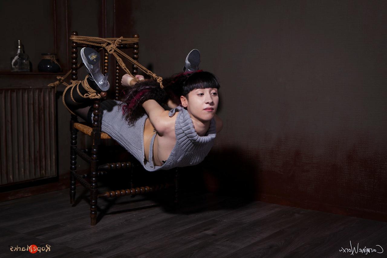 16P Solo girl Carmineworx is tied to a chair in a highly uncomfortable position