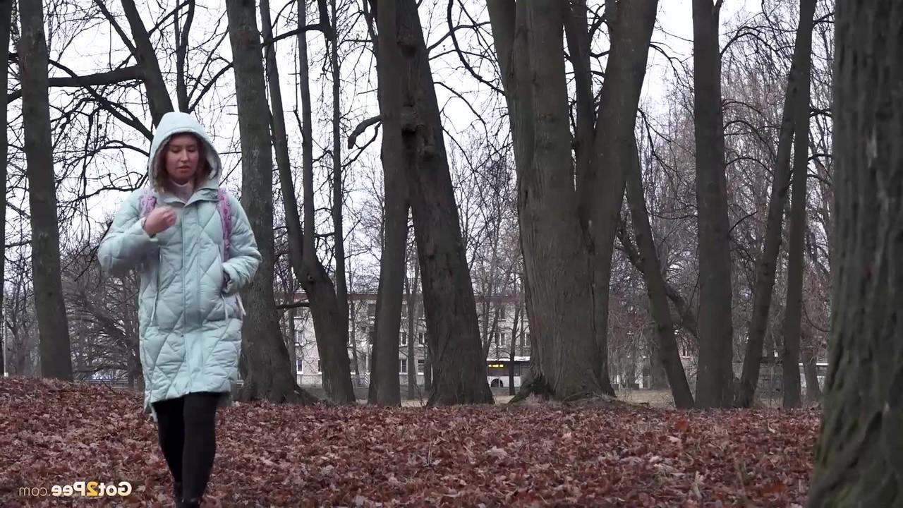 15P Distressed girl Rita pulls down her pantyhose to pee while walking in a forest