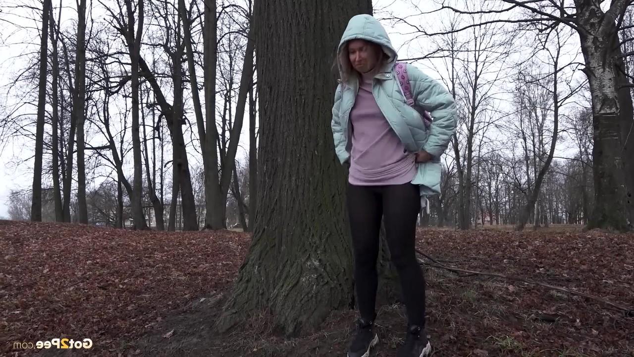15P Distressed girl Rita pulls down her pantyhose to pee while walking in a forest