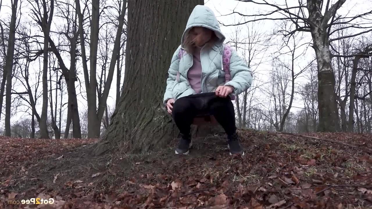 15P Distressed girl Rita pulls down her pantyhose to pee while walking in a forest