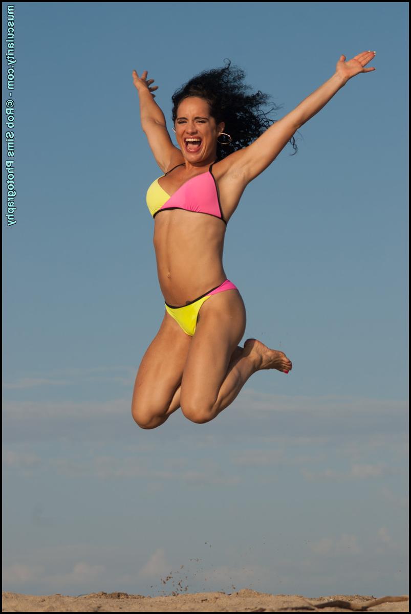 15P Bodybuilder Leila Denio poses in bikinis during solo action at a beach