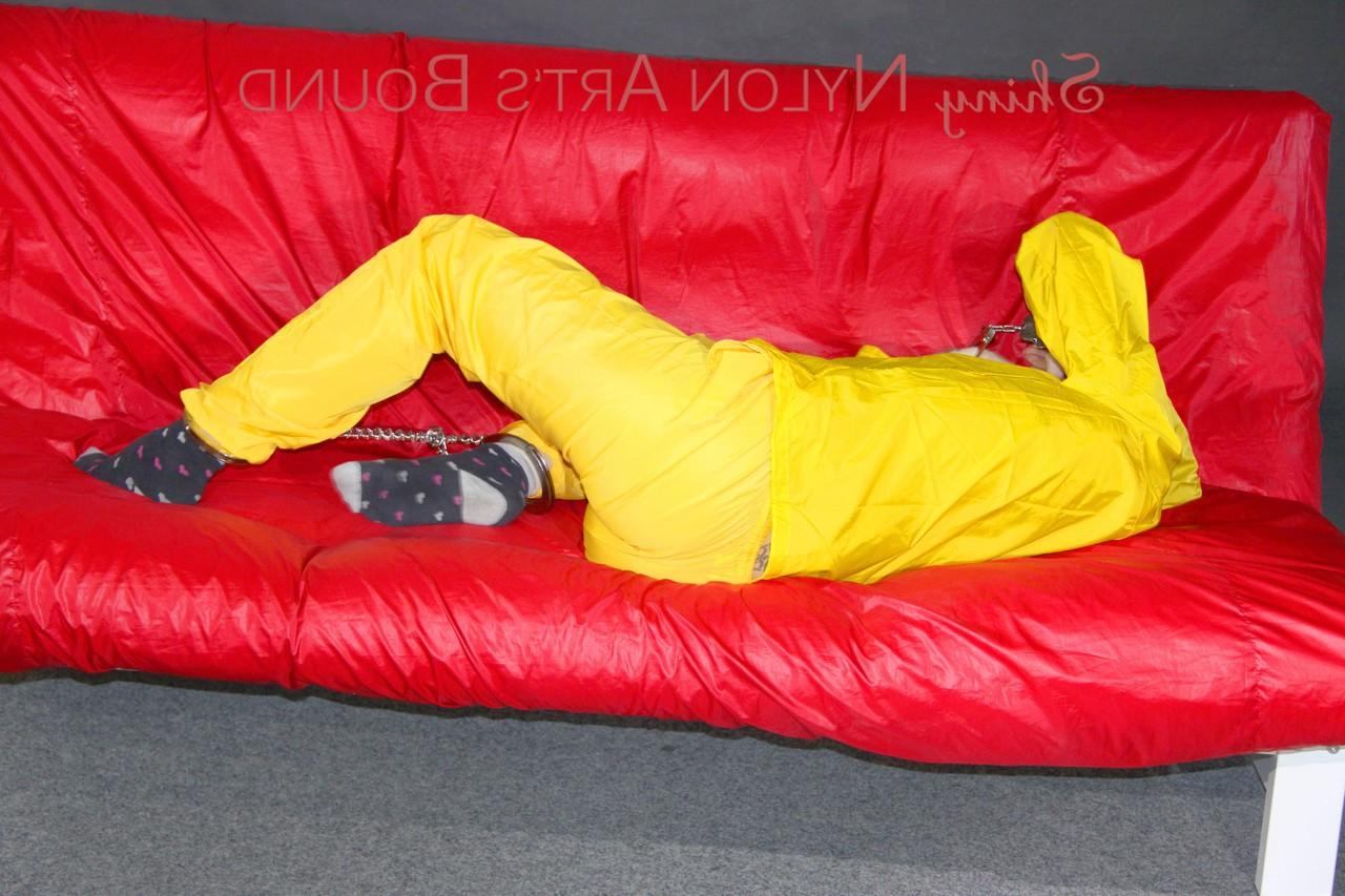16P White girl is restrained with cuffs and chain while gagged in nylon attire