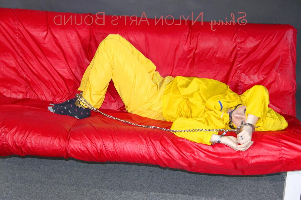 16P White girl is restrained with cuffs and chain while gagged in nylon attire