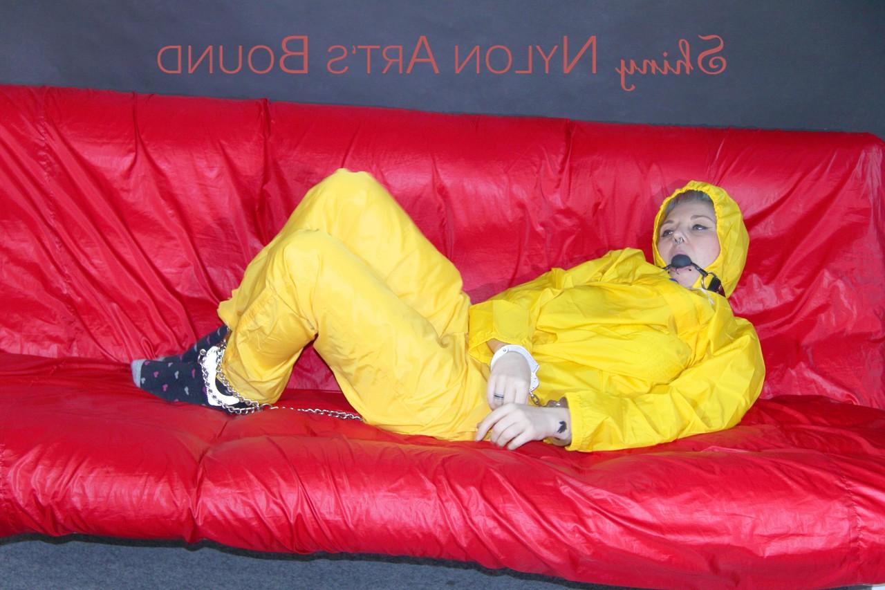 16P White girl is restrained with cuffs and chain while gagged in nylon attire