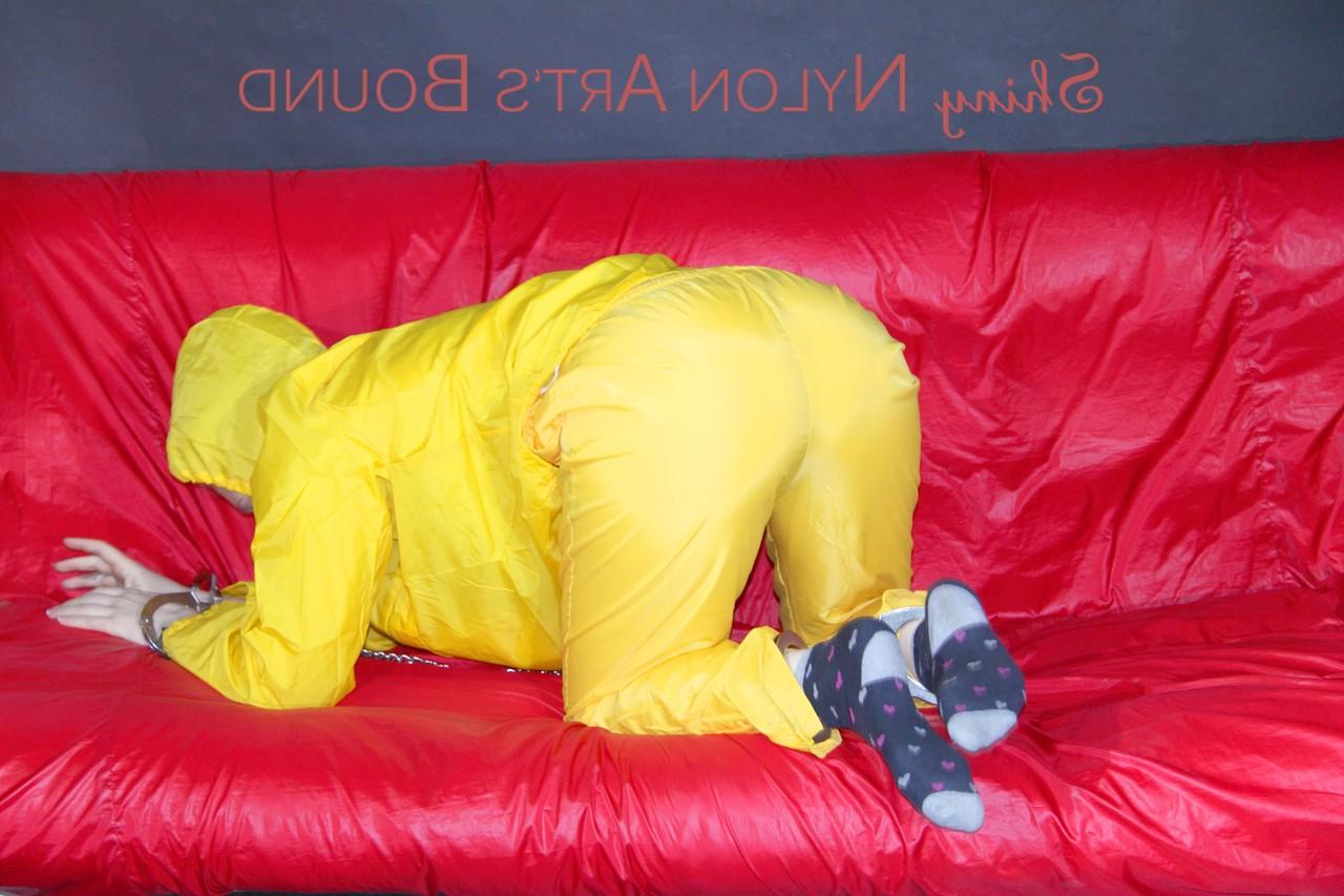 16P White girl is restrained with cuffs and chain while gagged in nylon attire