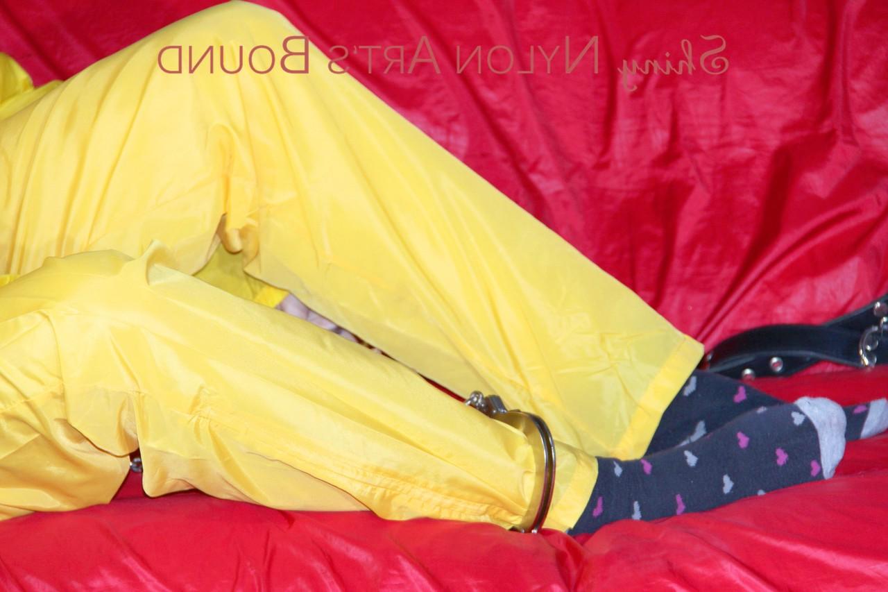 16P White girl is restrained with cuffs and chain while gagged in nylon attire