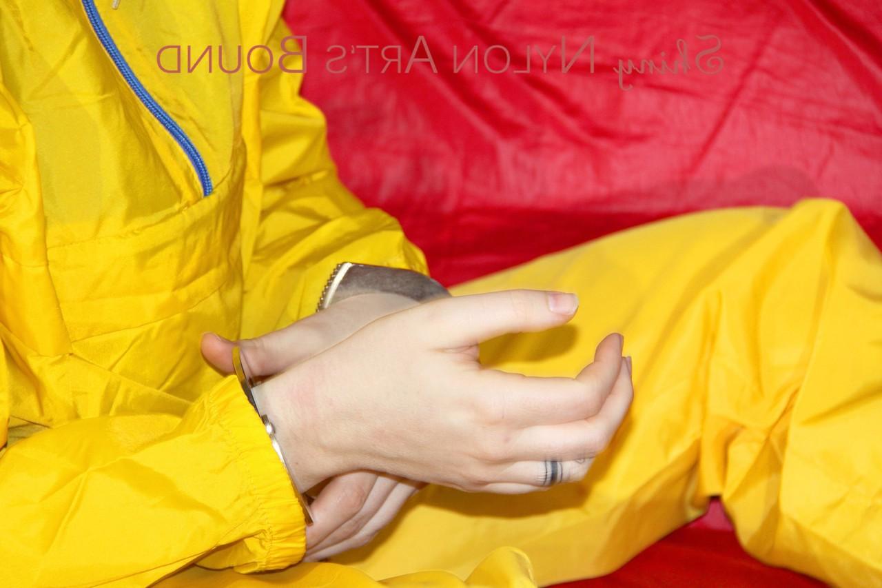 16P White girl is restrained with cuffs and chain while gagged in nylon attire