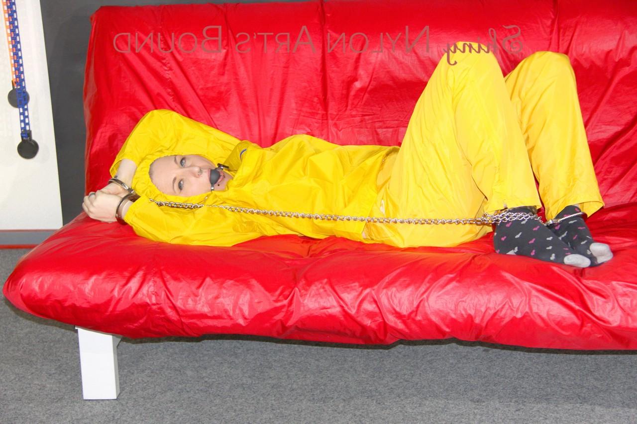 16P White girl is restrained with cuffs and chain while gagged in nylon attire
