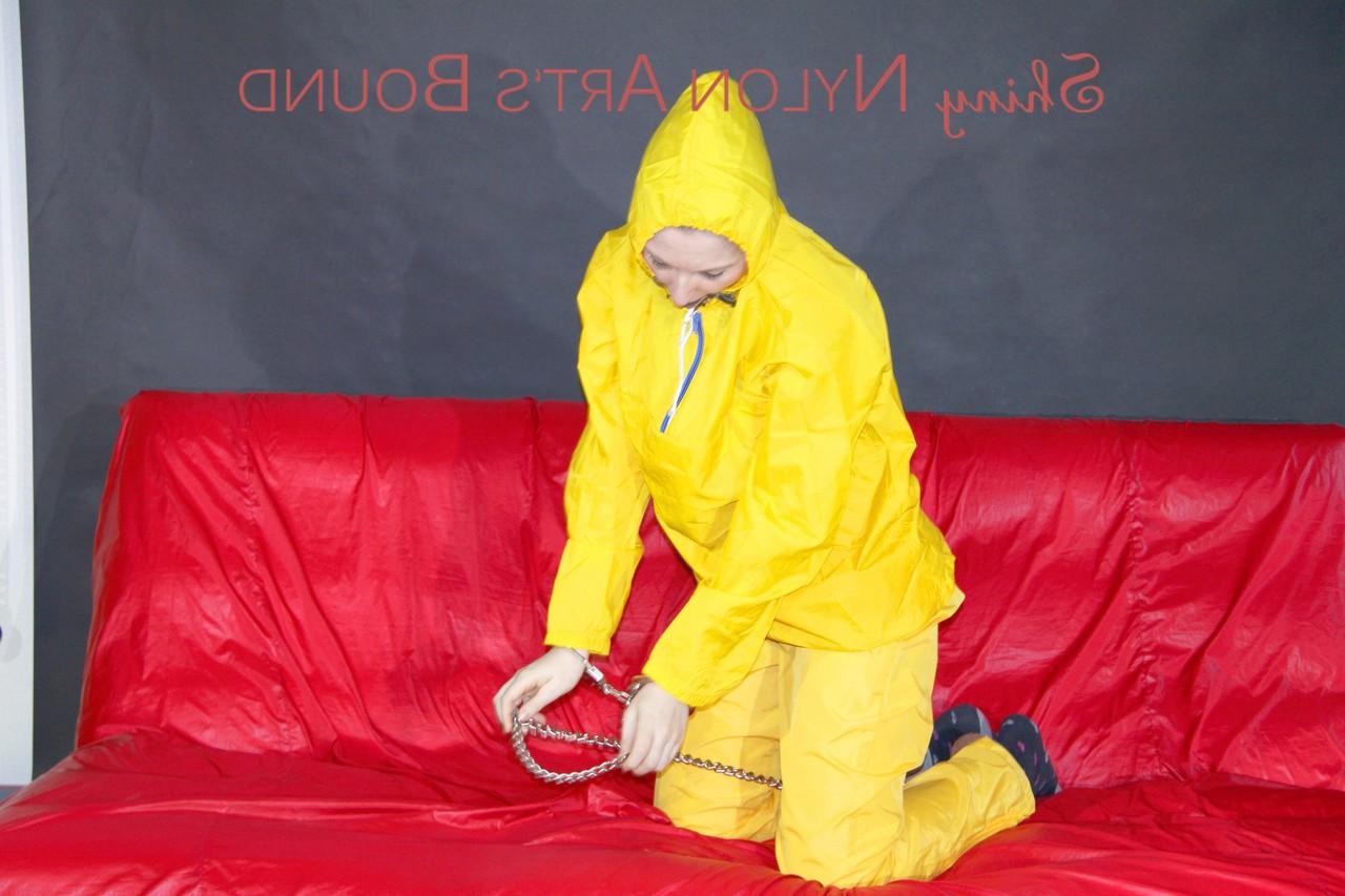 16P White girl is restrained with cuffs and chain while gagged in nylon attire