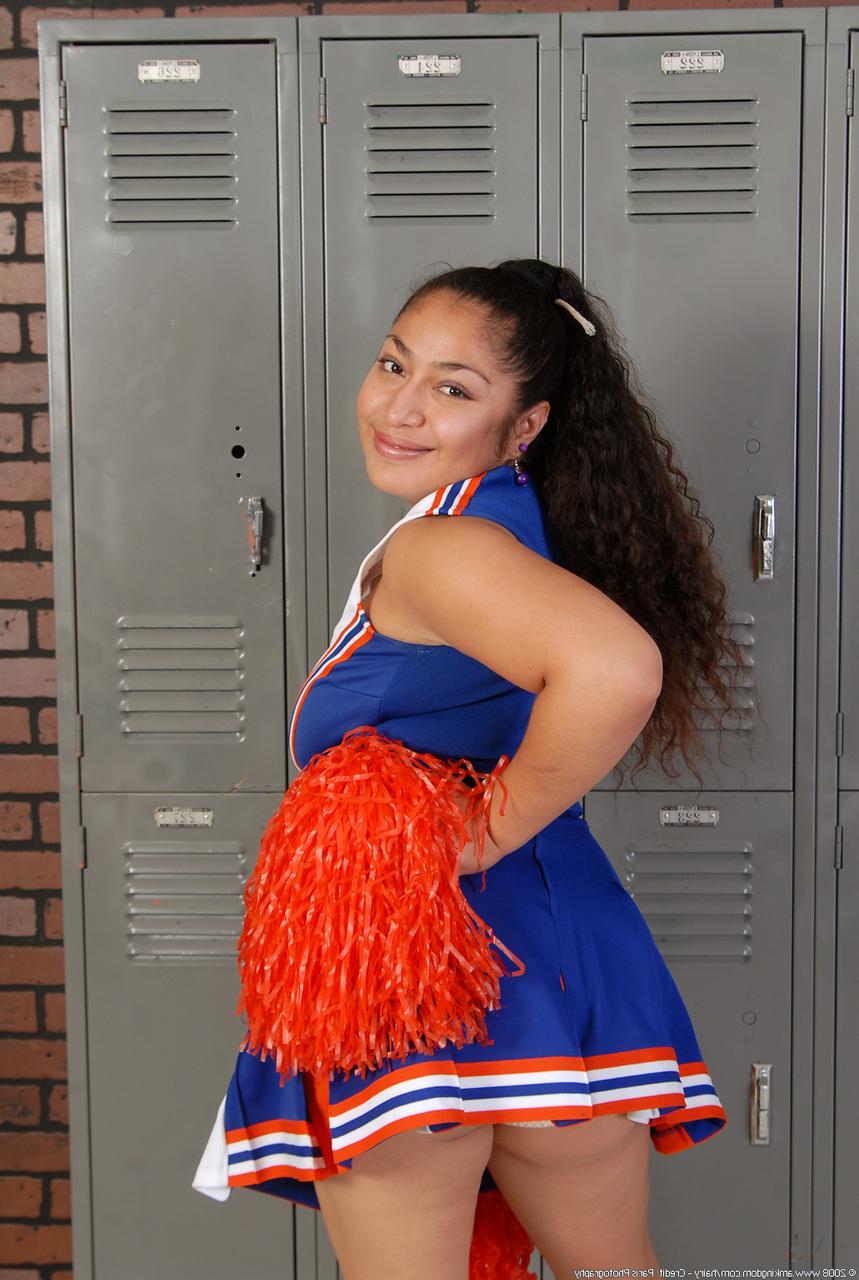 20P Petite curly haired cheerleader Reena shows her fat ass and hairy pussy