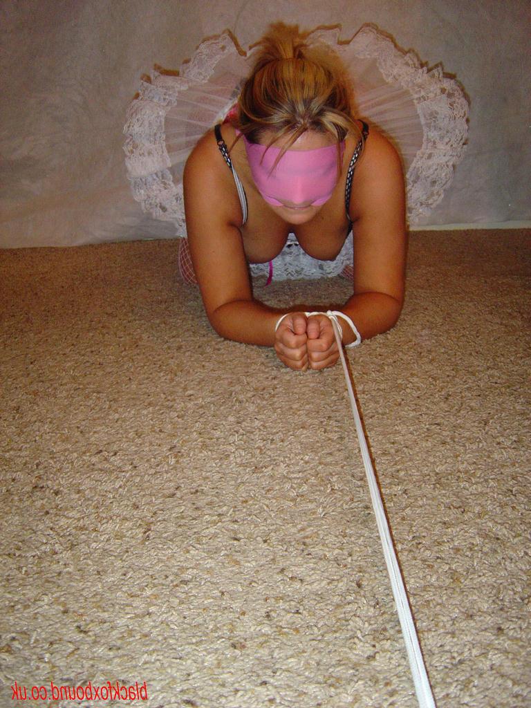 14P Caucasian girl is tied up with rope while blindfolded in a tutu and heels