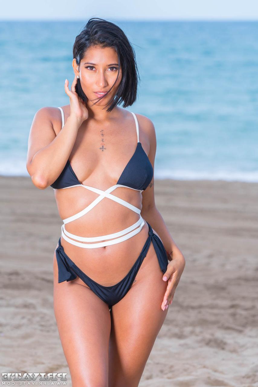 12P Latina chick Alika Penagos models on a beach before sex with a thick cock