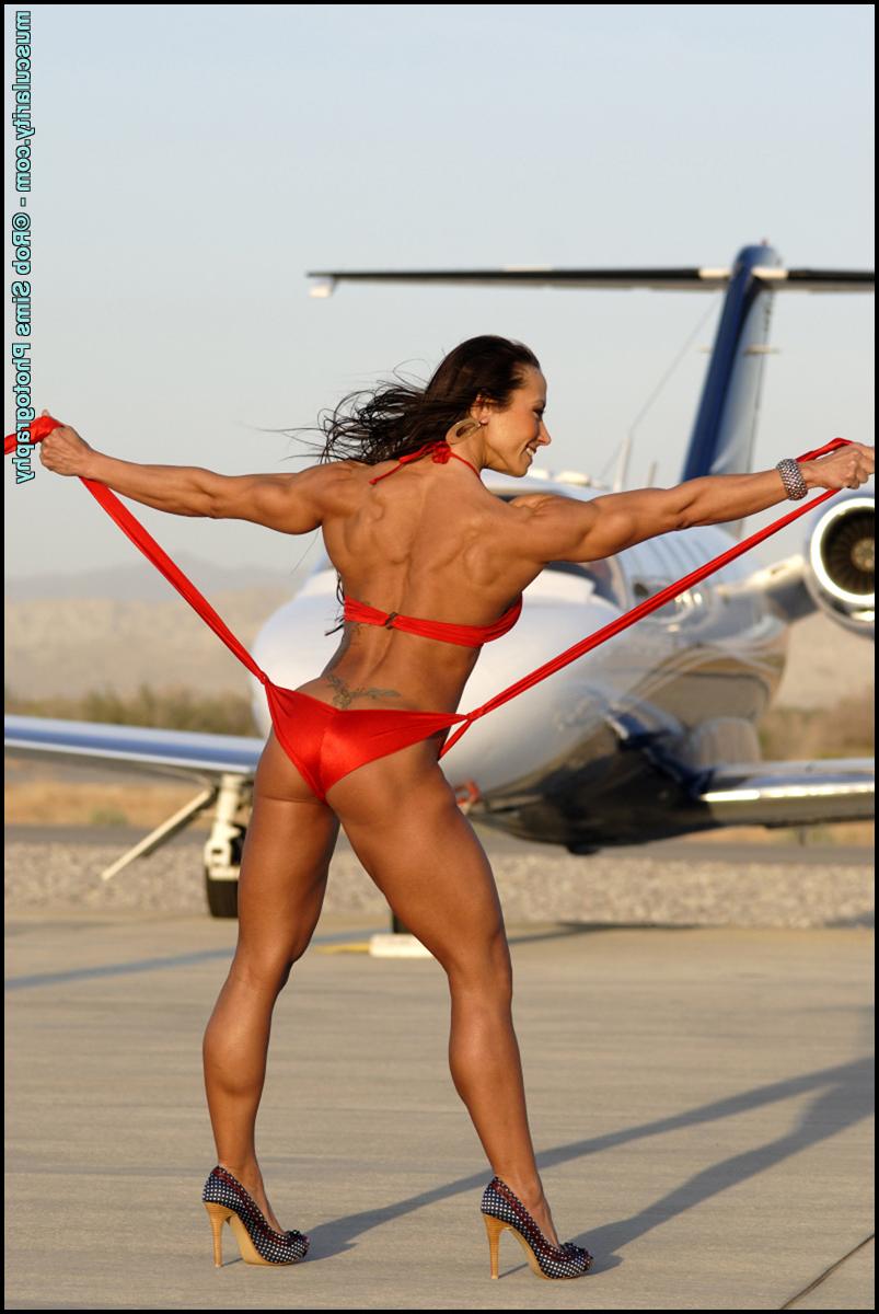 15P Bodybuilder Patricia Beckman poses in a red bikini afore a private jet