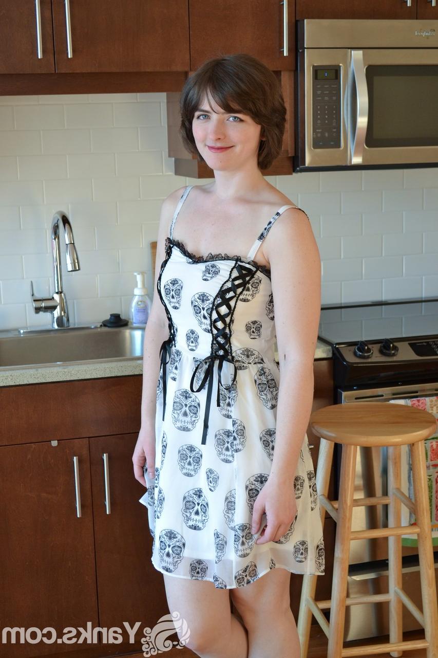 16P Pale short haired Raven Snow strips to model her shaved pussy & natural tits