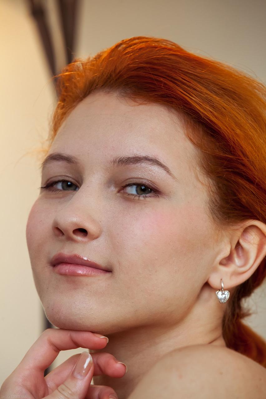 20P Skinny redheaded babe Ambre doffs her clothes and poses nude in a solo