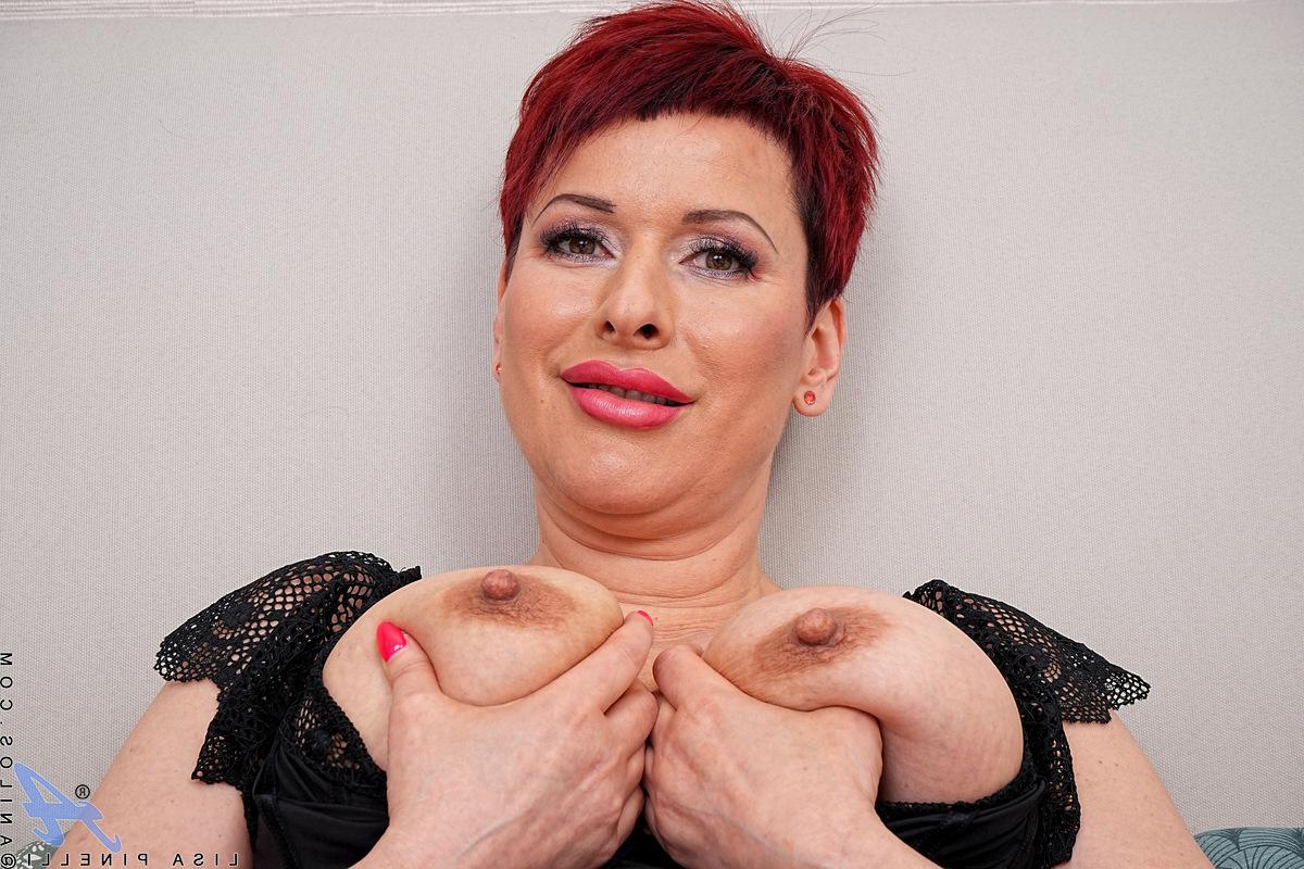 16P MILF with short red hair Lisa Pinelli spreads her pink pussy on a bed