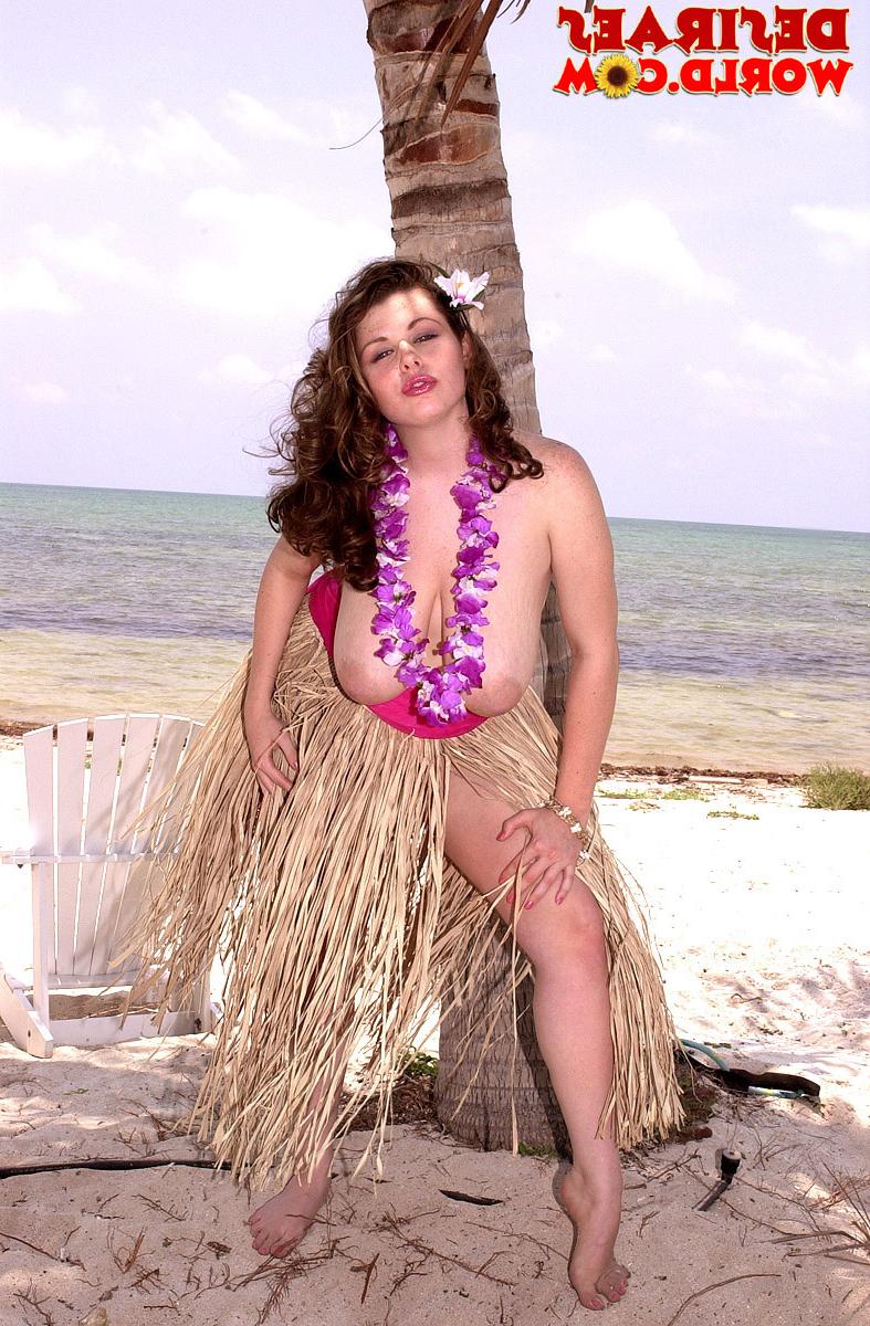16P Big titted chick Desirae exposes herself on a tropical beach in a grass skirt