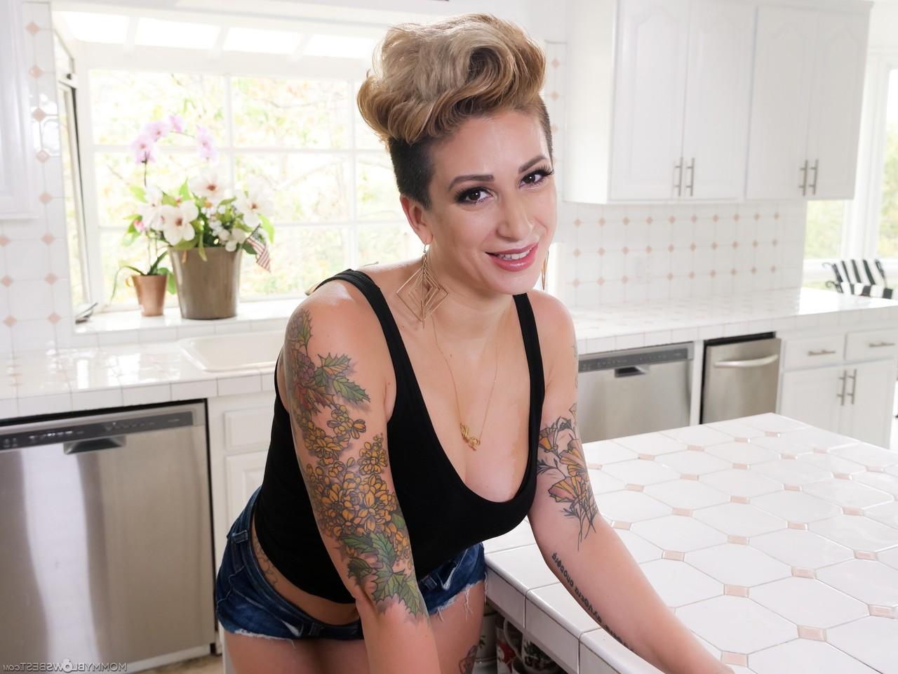 15P Tattooed MILF Della Dane has POV sex with a big cock in her kitchen