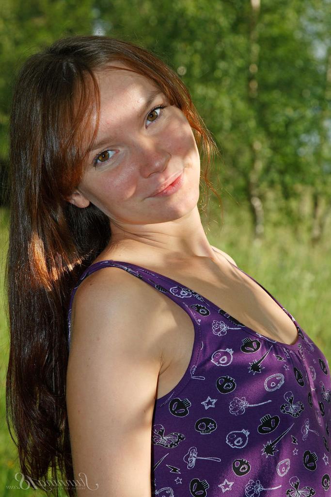 16P 18 year old redhead Anastasia slips off her dress to pose nude by some trees