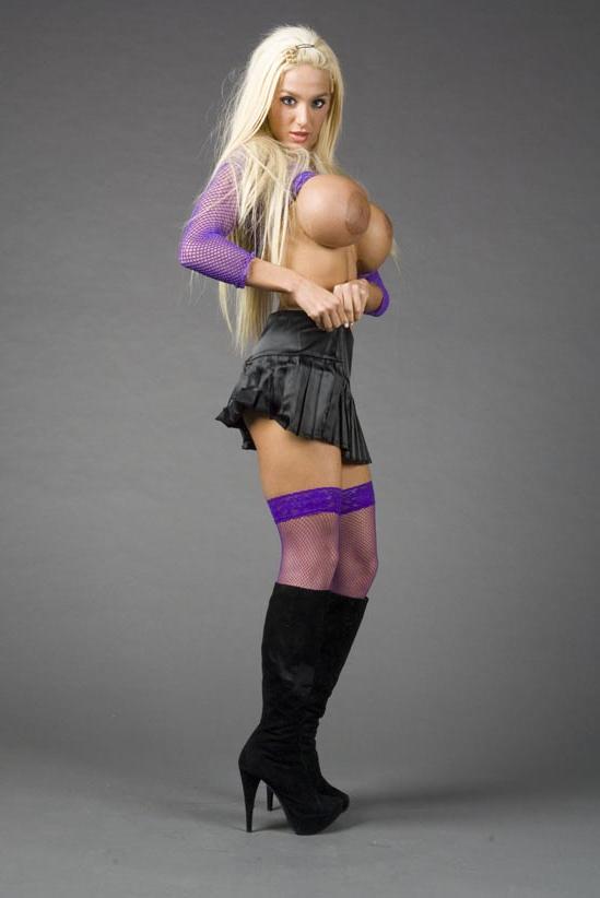 20P La star blonde du porno Amy Azurra dévoile ses énormes seins et pose dans des bas violets.