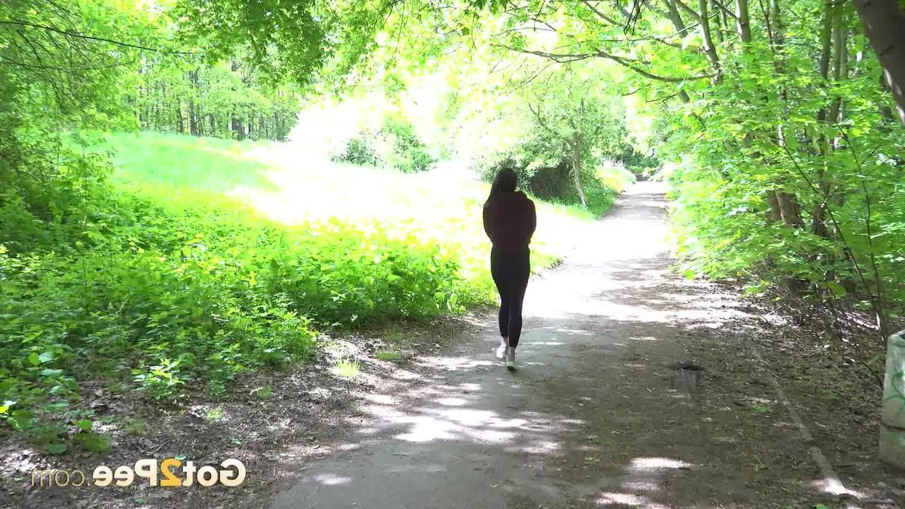15P Barbe pulls down black leggings to pee on a roadway through the woods