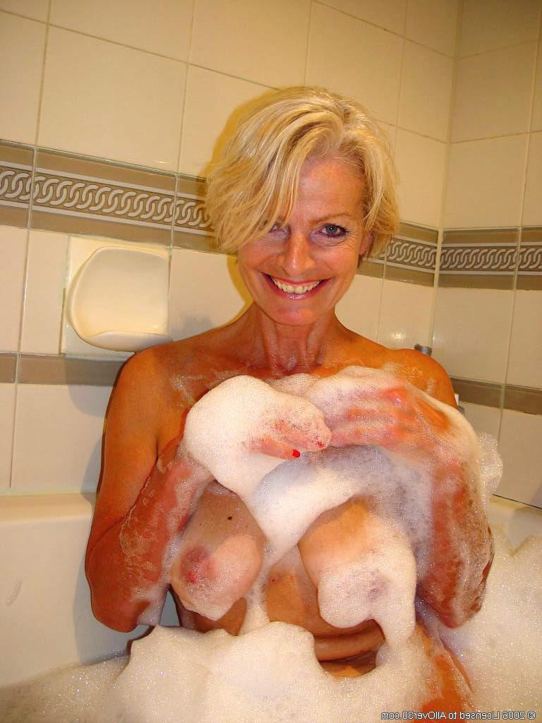 20P Die hübsche reife Frau Justine seift ihre großen Brüste und ihre haarige Muschi in der Badewanne ein
