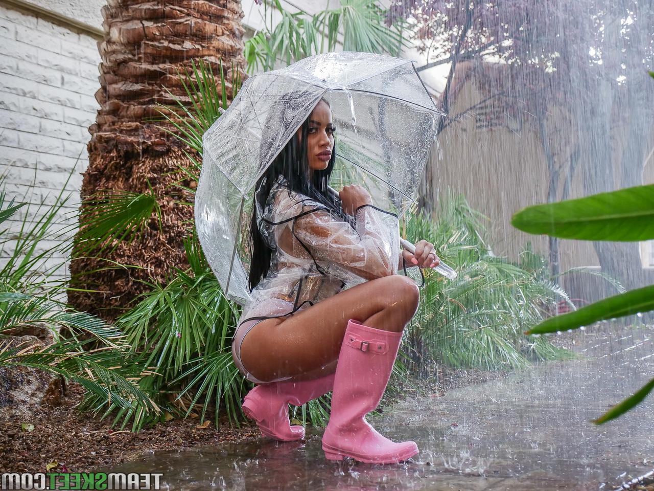 16P Ebony bombshell Victoria June bares enhanced big tits to fuck in rubber boots