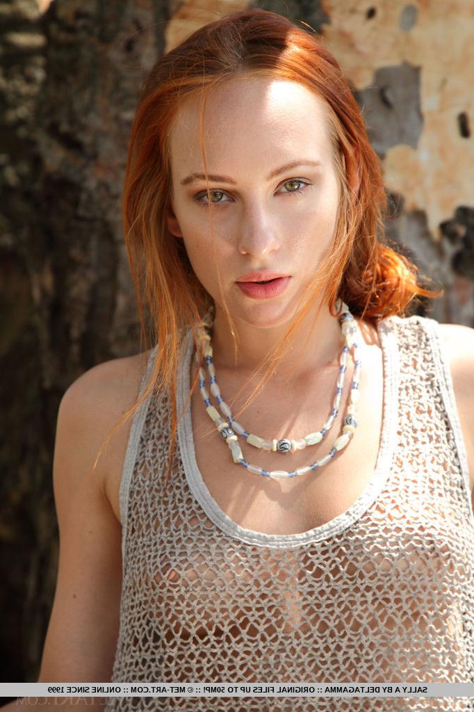 18P Pale redhead European Sally A stripping to show hairy pussy in the woods