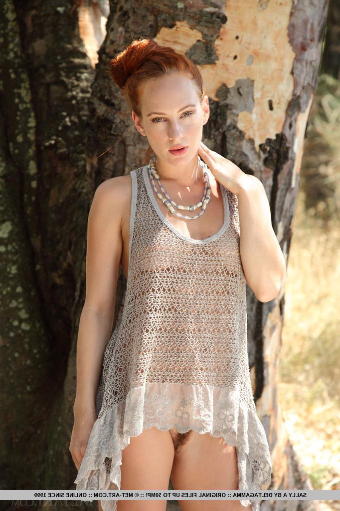 18P Pale redhead European Sally A stripping to show hairy pussy in the woods