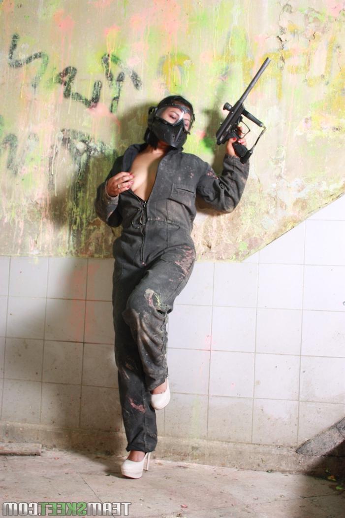 19P Colombian brunette Sandra Flores strips to her lingerie on the paintball field
