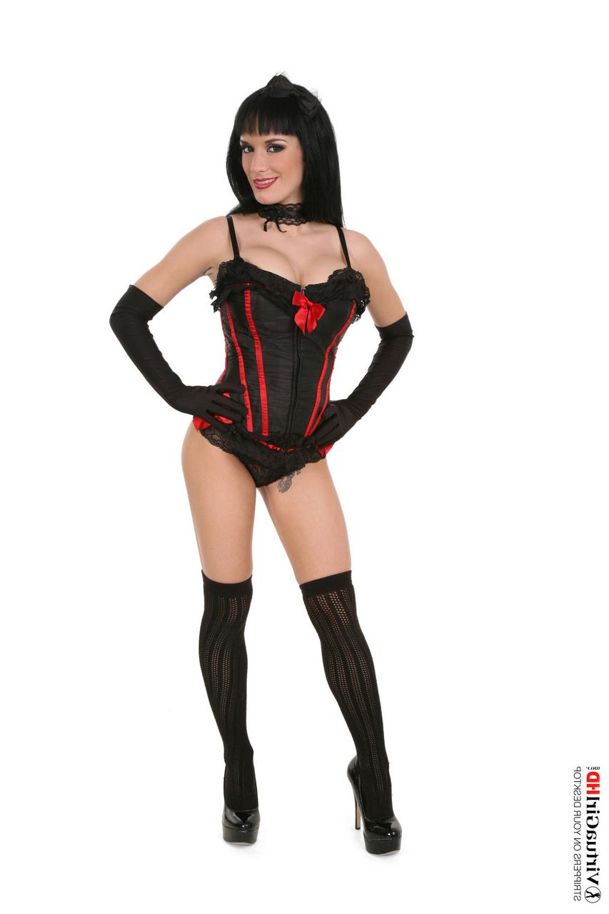 15P Sexy brunette Rebeka doffs a corset while wearing opera gloves and OTK nylons