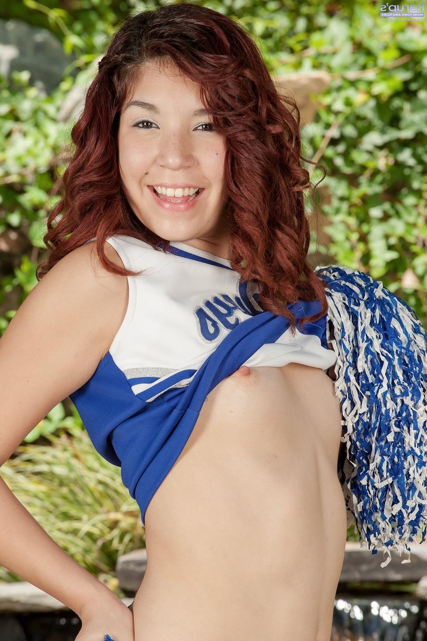 20P Redheaded Latina cheerleader Leah Cortez presents her love holes outdoors