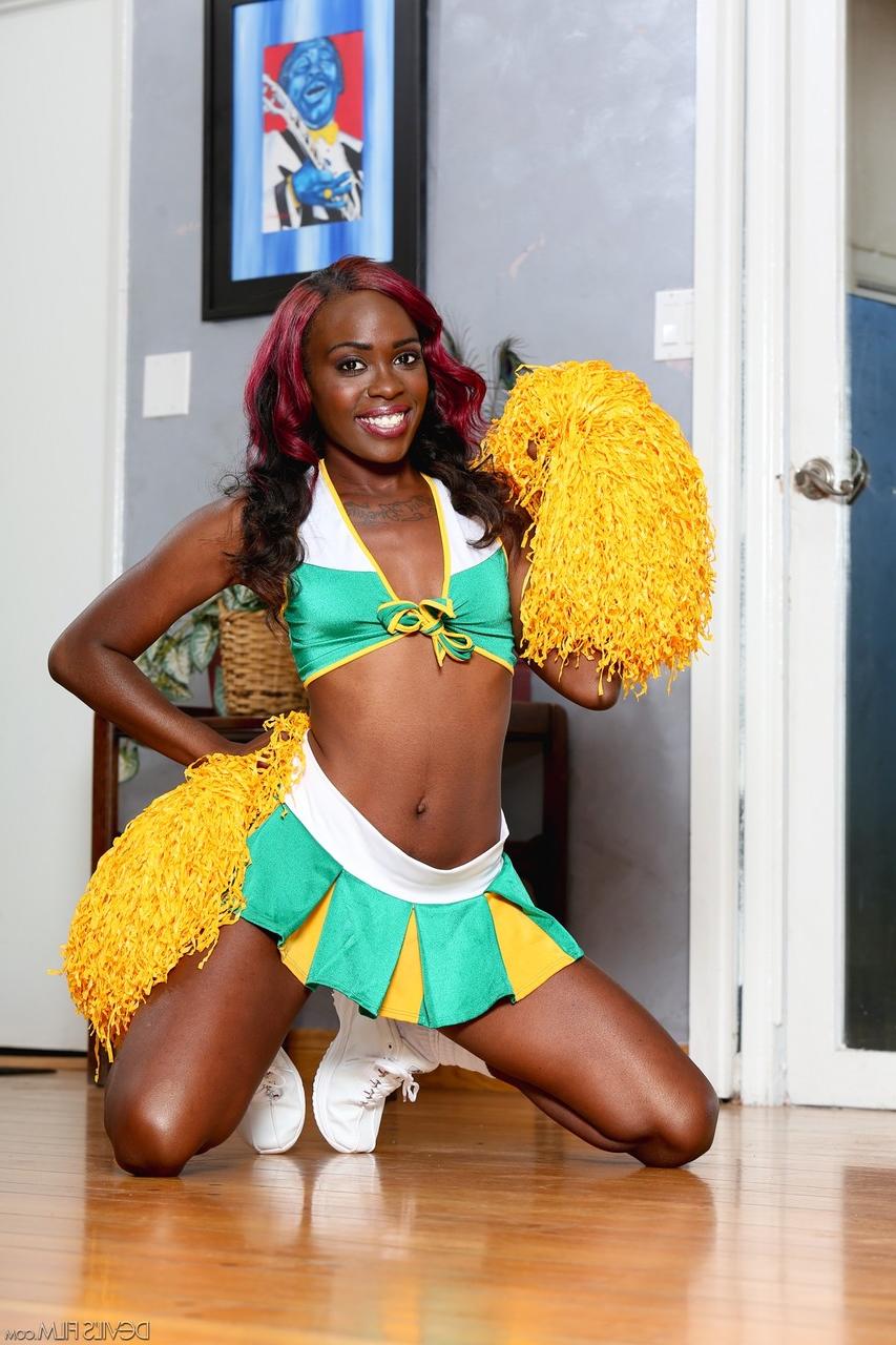 15P Ebony cheerleader Bella Doll frees her small tits and pussy from her uniform