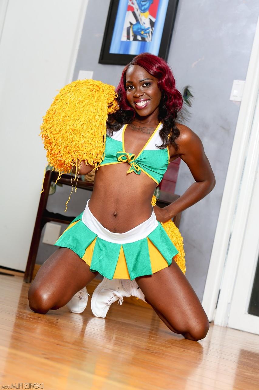 15P Ebony cheerleader Bella Doll frees her small tits and pussy from her uniform