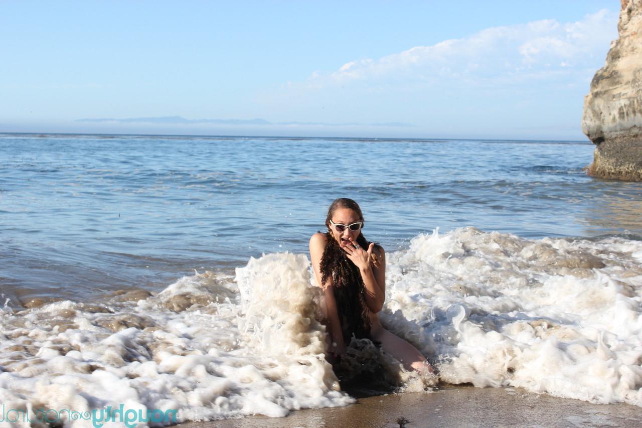 20P Amateur babe Maggie Mayhem teases with her big tits and poses on the beach
