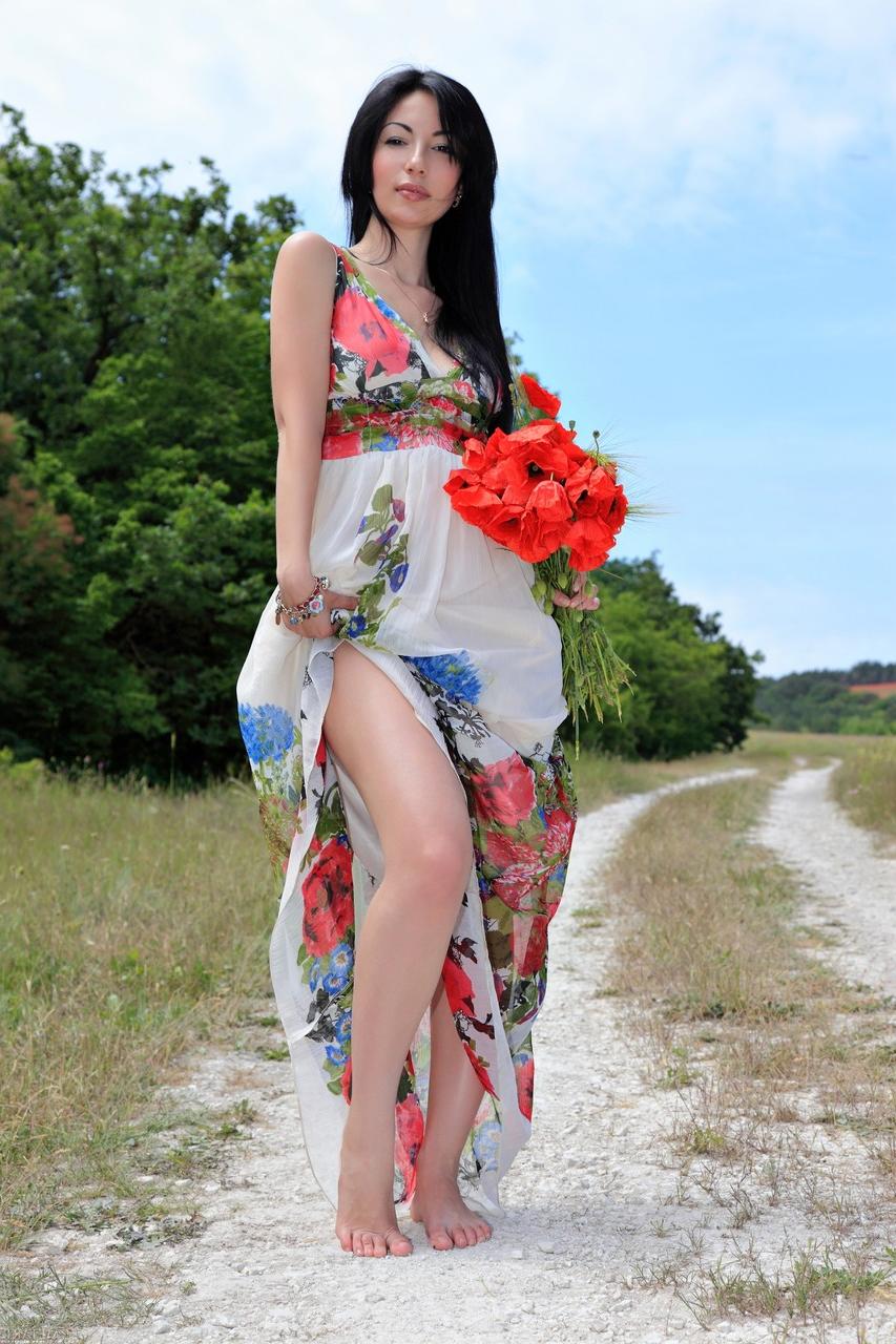 20P Glamorous babe Melani A strips in beautiful nature and poses naked