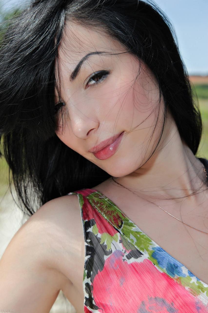 20P Glamorous babe Melani A strips in beautiful nature and poses naked