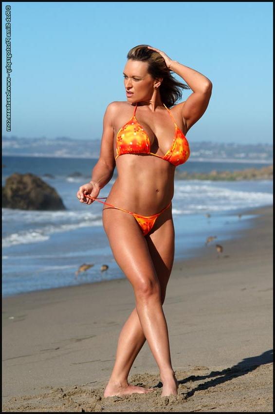 15P Solo model Kym More releases her big tits from a bikini while at the beach